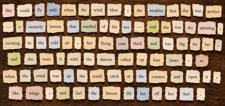Collage of Scrabble-like tiles arranged to form a long narrative about a girl who could fly when the wind blew, on a brown wooden background.